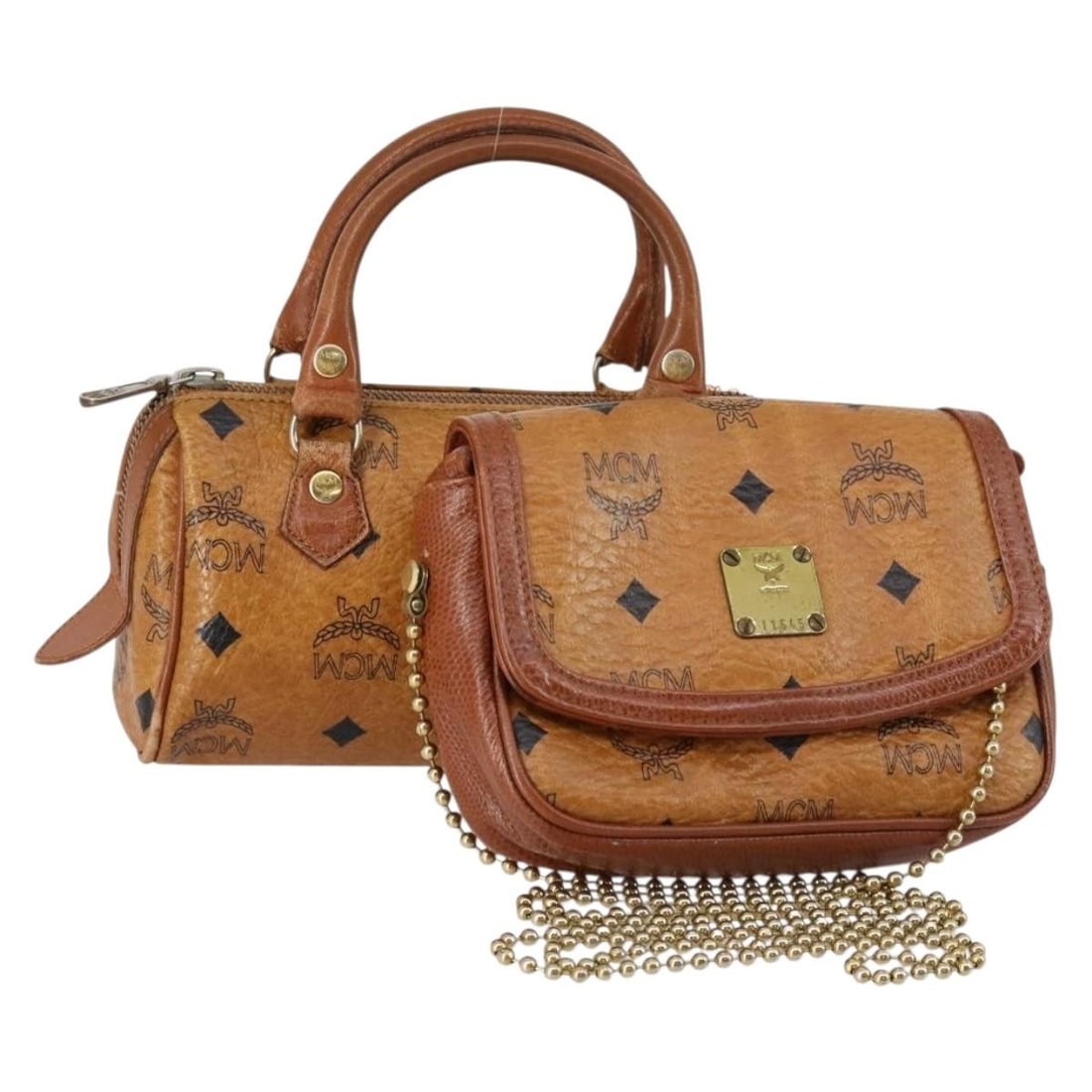 MCM Logogram Vicetos Brown Gold PVC Leather Hand Bag Set: MCM Logogram Vicetos Brown Gold PVC Leather Hand Bag Set This MCM Logogram Vicetos Hand Bag set features a stylish combination of brown and gold PVC leather. The bag showcases a distinct design that e