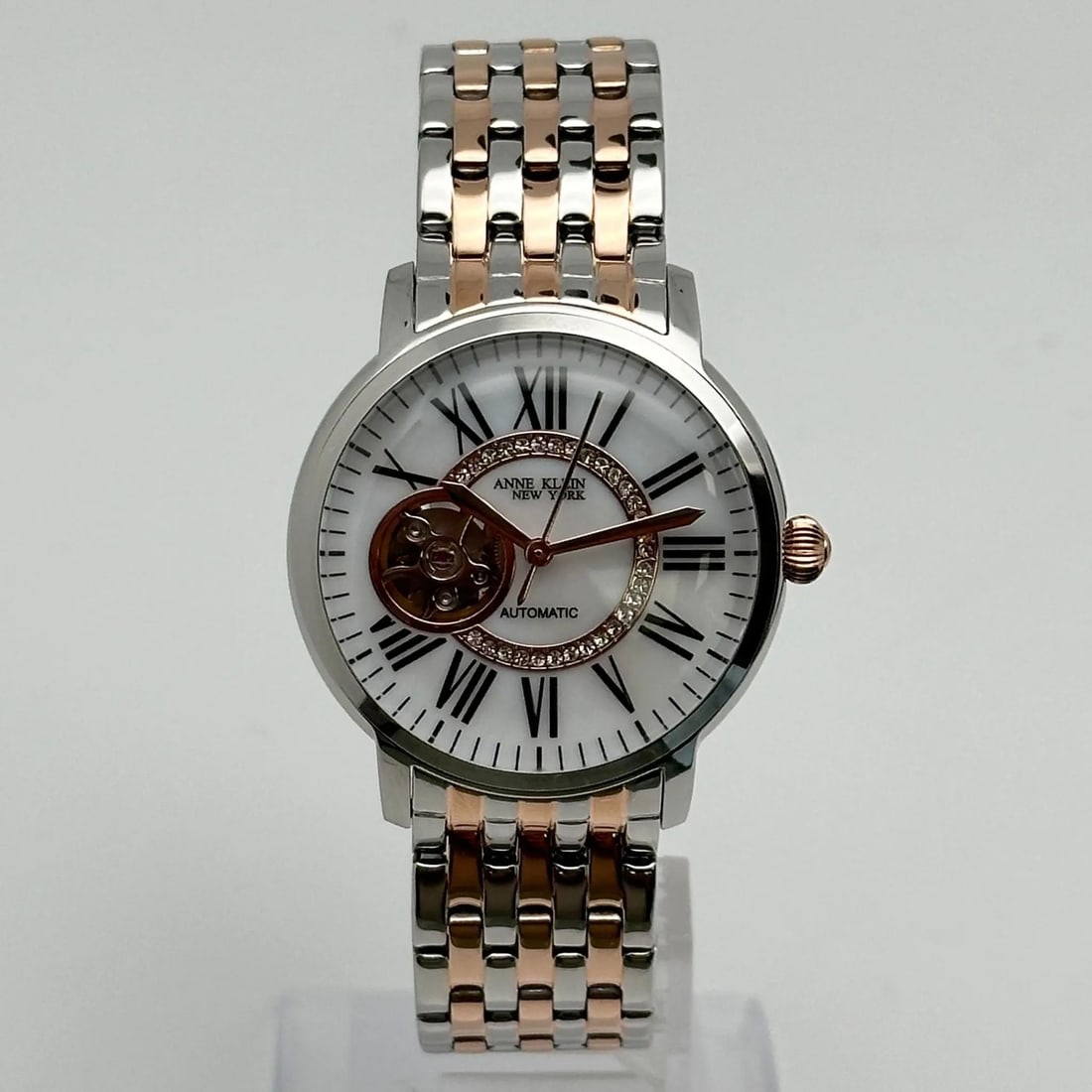 Anne Klein 36mm Two Tone Automatic Ladies Watch Y121E Gray Rose Gold: Anne Klein 36mm Two Tone Automatic Ladies Watch Y121E Gray Rose Gold This Anne Klein wristwatch features a stylish 36mm round case with a polished stainless steel finish. The elegant white dial displa