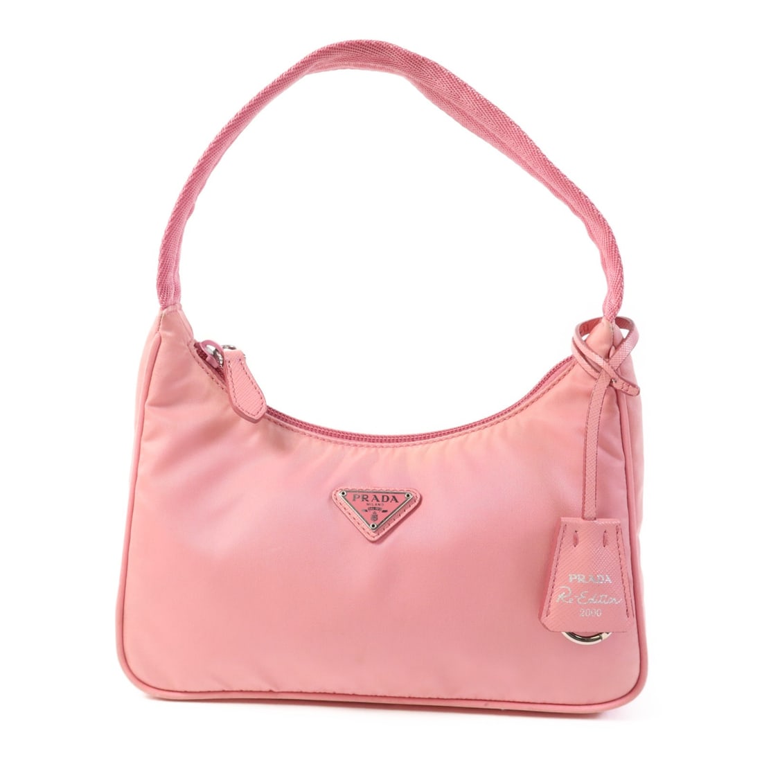 Prada Re Edition 2000 Nylon Pink Handbag: Prada Re Edition 2000 Nylon Pink Handbag This PRADA Niryu Re-Edition 2000 Ginpaku handbag is crafted from pink nylon and features a handmade design. Made in Italy, it offers a compact silhouette with 