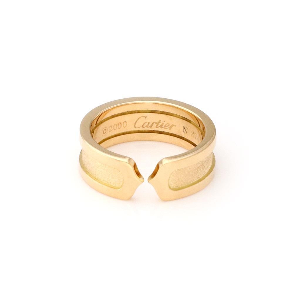 Cartier Double C Cuff Ring 18k Yellow Gold Size 50 with Certification: Cartier Double C Cuff Ring 18k Yellow Gold Size 50 with Certification This authentic Cartier Double C cuff band ring is expertly crafted from 18k yellow gold. The ring showcases a stunning combination