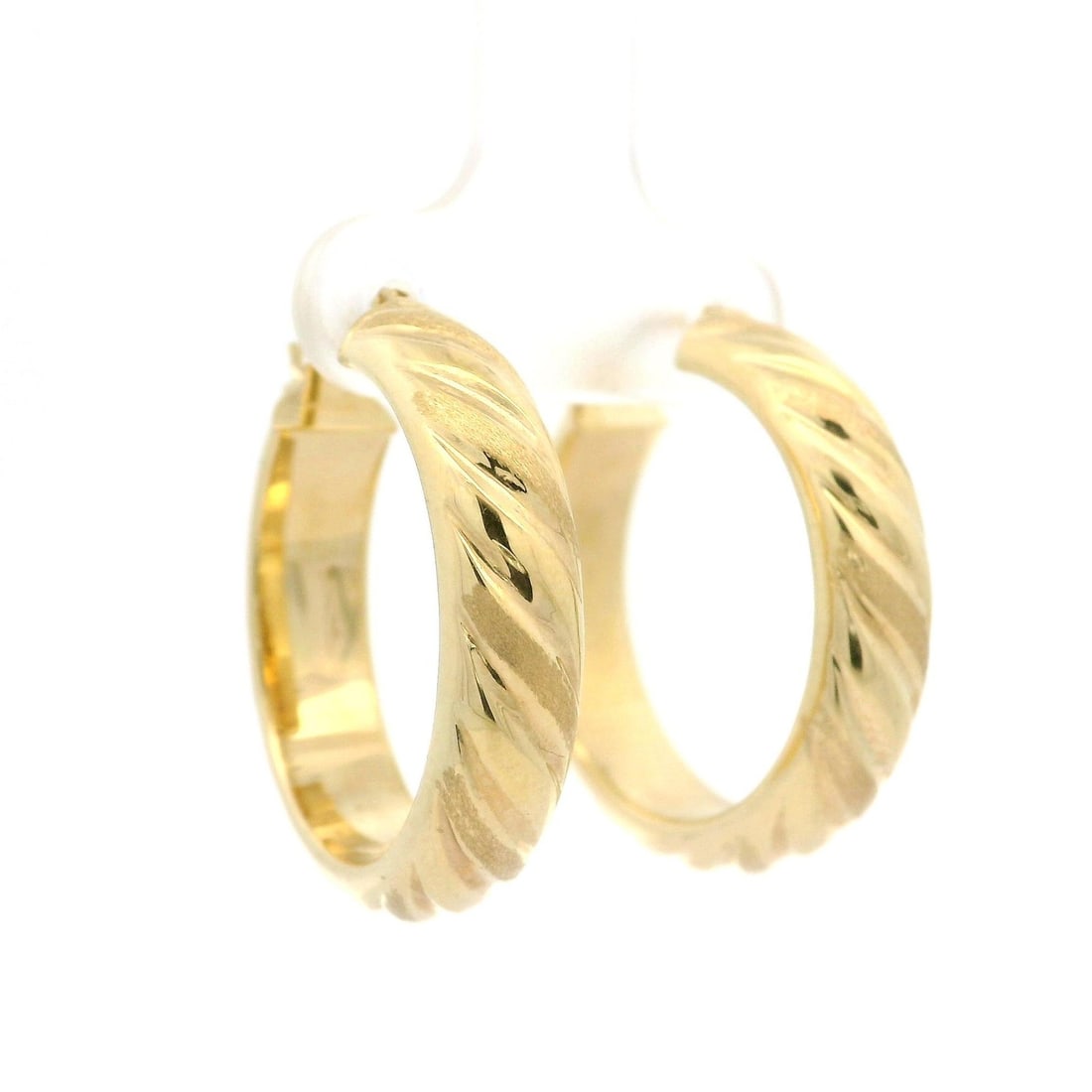 14K Yellow Gold Ribbed 26mm Hoop Earrings: 14K Yellow Gold Ribbed 26mm Hoop Earrings These exquisite hoop earrings feature a stunning dual finish ribbed design crafted from solid 14K yellow gold. With a hollow construction, these lightweight e