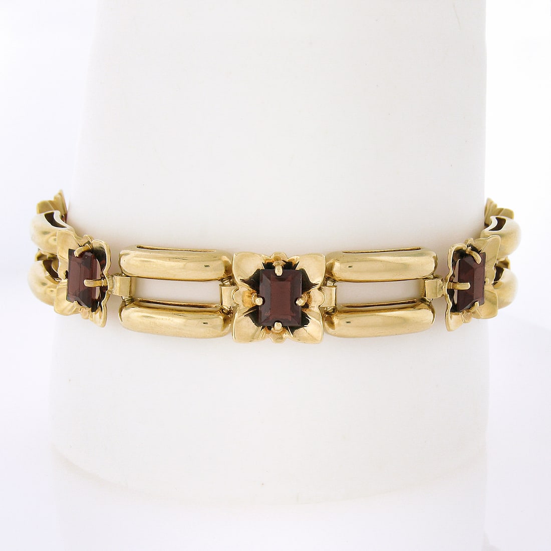 Vintage 14K Yellow Gold Floral Garnet Bracelet 7.5 Inch: Vintage 14K Yellow Gold Floral Garnet Bracelet 7.5 Inch This exquisite vintage bracelet features a stunning floral design crafted from solid 14K yellow gold. The piece measures 7.5 inches in length an