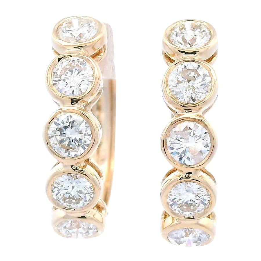 1.43ct Diamond Yellow Gold Hoop Earrings: 1.43ct Diamond Yellow Gold Hoop Earrings These exquisite 1.43ct diamond bezel set hoop earrings are crafted in 14k yellow gold, showcasing a contemporary design. Each earring features ten round brilli