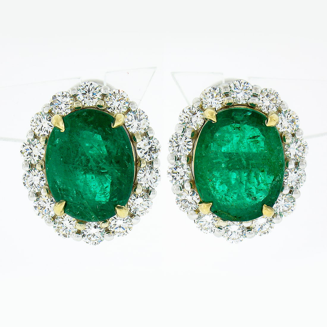 18K Two Tone Gold 13.04ctw GIA Oval Emerald Diamond Halo Earrings: 18K Two Tone Gold 13.04ctw GIA Oval Emerald Diamond Halo Earrings Elevate your elegance with these stunning 18K Two Tone Gold earrings, featuring a breathtaking 13.04 carat total weight of GIA-certifi