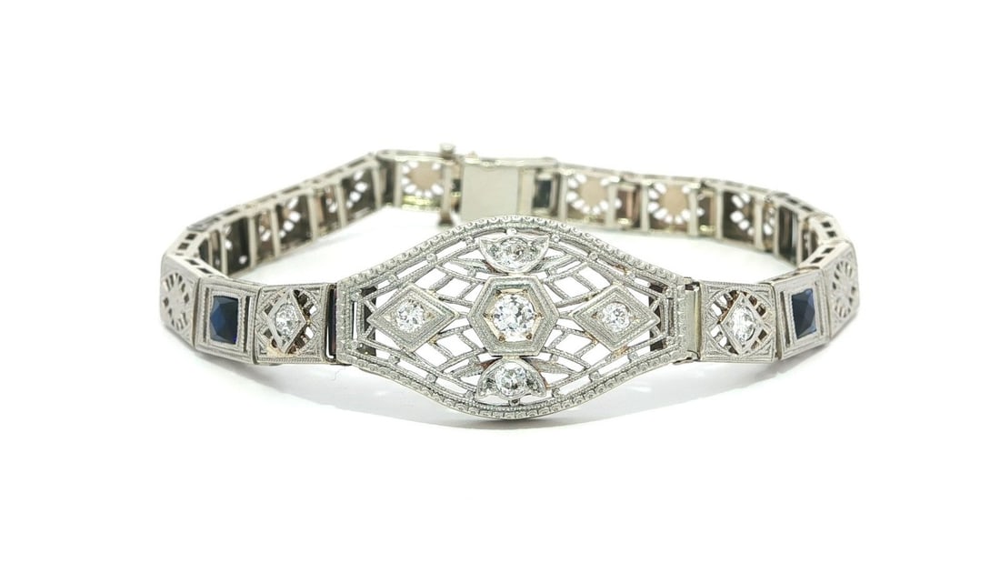 Antique Art Deco 14k White Gold Filigree Bracelet with Diamonds and Sapphires: Antique Art Deco 14k White Gold Filigree Bracelet with Diamonds and Sapphires This exquisite Antique Art Deco bracelet showcases a stunning combination of gold and platinum featuring old cut diamonds 
