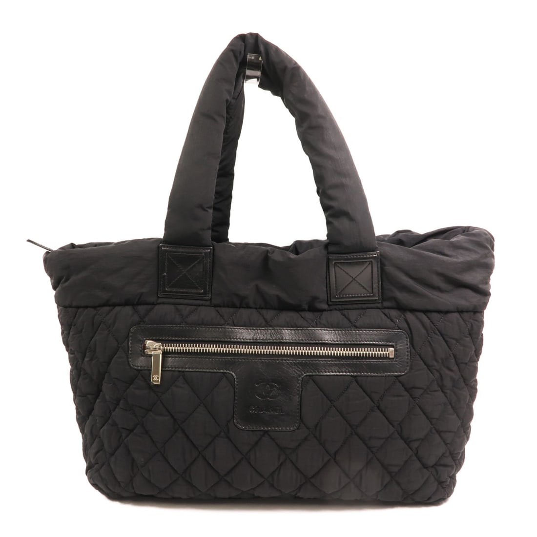 Coco Cocoon Black Nylon Tote Shoulder Bag with Silver Hardware by Chanel: Coco Cocoon Black Nylon Tote Shoulder Bag with Silver Hardware by Chanel This Chanel CC Coco Cocoon tote bag features a sleek black nylon exterior and a spacious design, ideal for daily use. Designed 