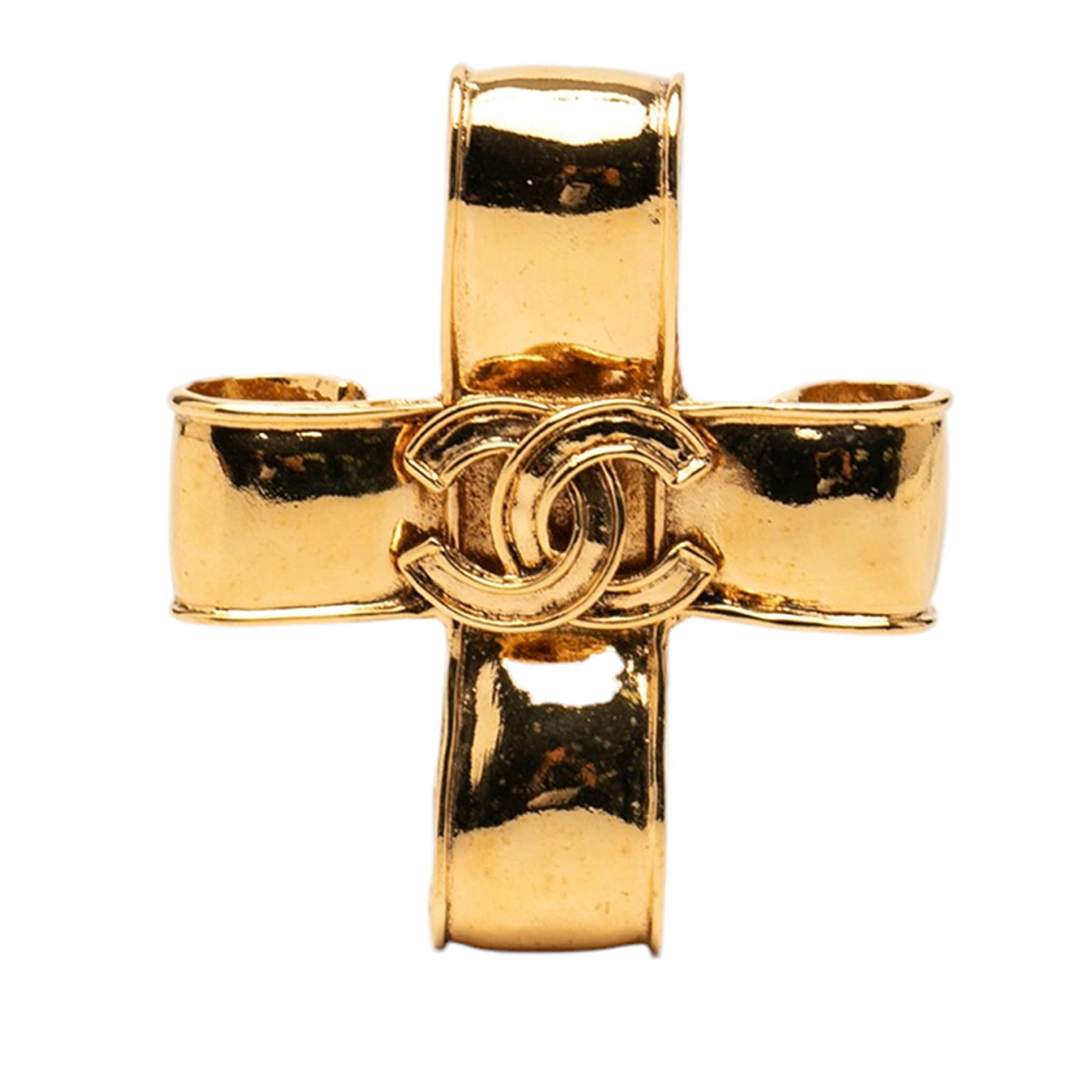Chanel CC Ribbon Cross Brooch Gold Tone Metal: Chanel CC Ribbon Cross Brooch Gold Tone Metal Chanel CC ribbon cross brooch in gold tone metal with a back pin closure. Made in France, this costume jewelry piece features the iconic CC motif in a rib