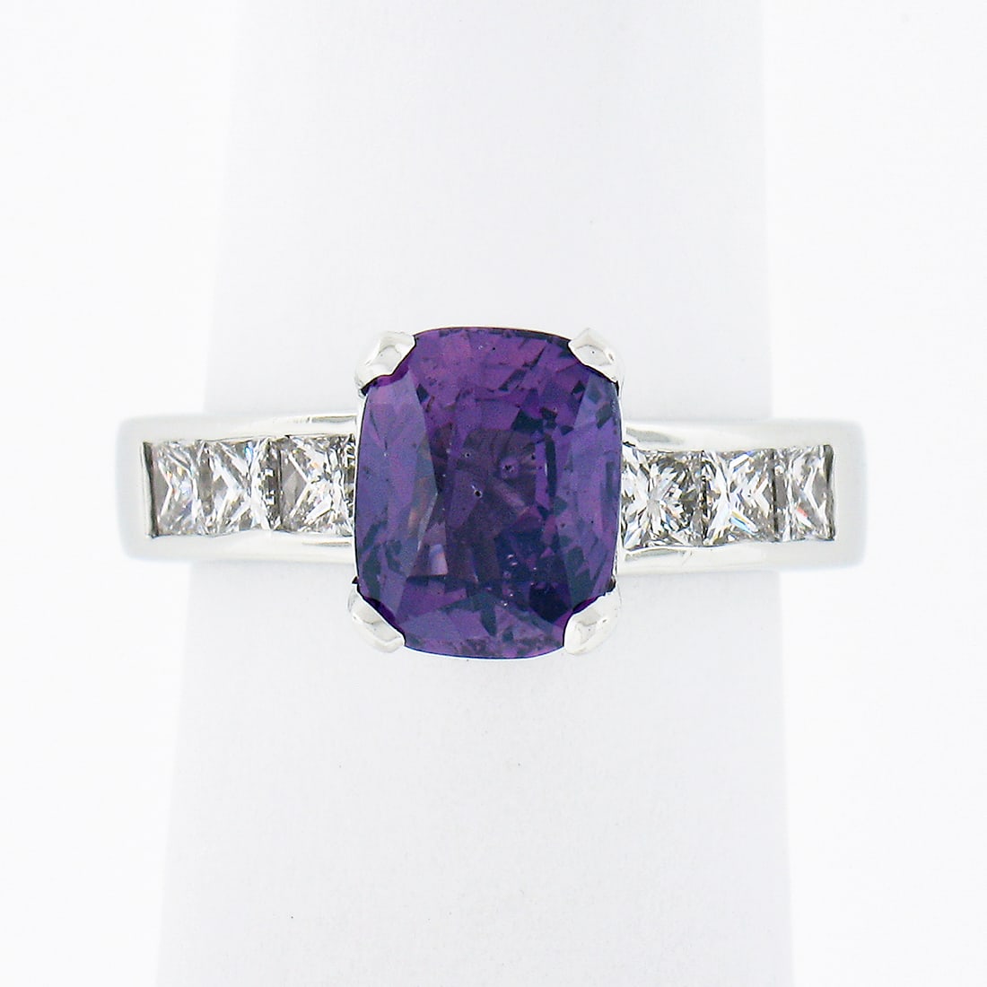 GIA Platinum Ring with Cushion Purple Sapphire and Diamond Sides: GIA Platinum Ring with Cushion Purple Sapphire and Diamond Sides This vintage engagement ring is crafted in solid .950 platinum and showcases a GIA-certified, cushion brilliant cut Ceylon purple sapph