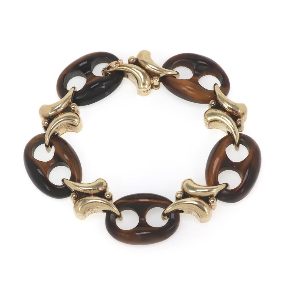 Vintage 14k Yellow Gold Tiger's Eye Mariner Link Bracelet: Vintage 14k Yellow Gold Tiger's Eye Mariner Link Bracelet This stunning vintage bracelet is expertly crafted from 14k yellow gold, showcasing an elegant design featuring five large carved tiger's eye 