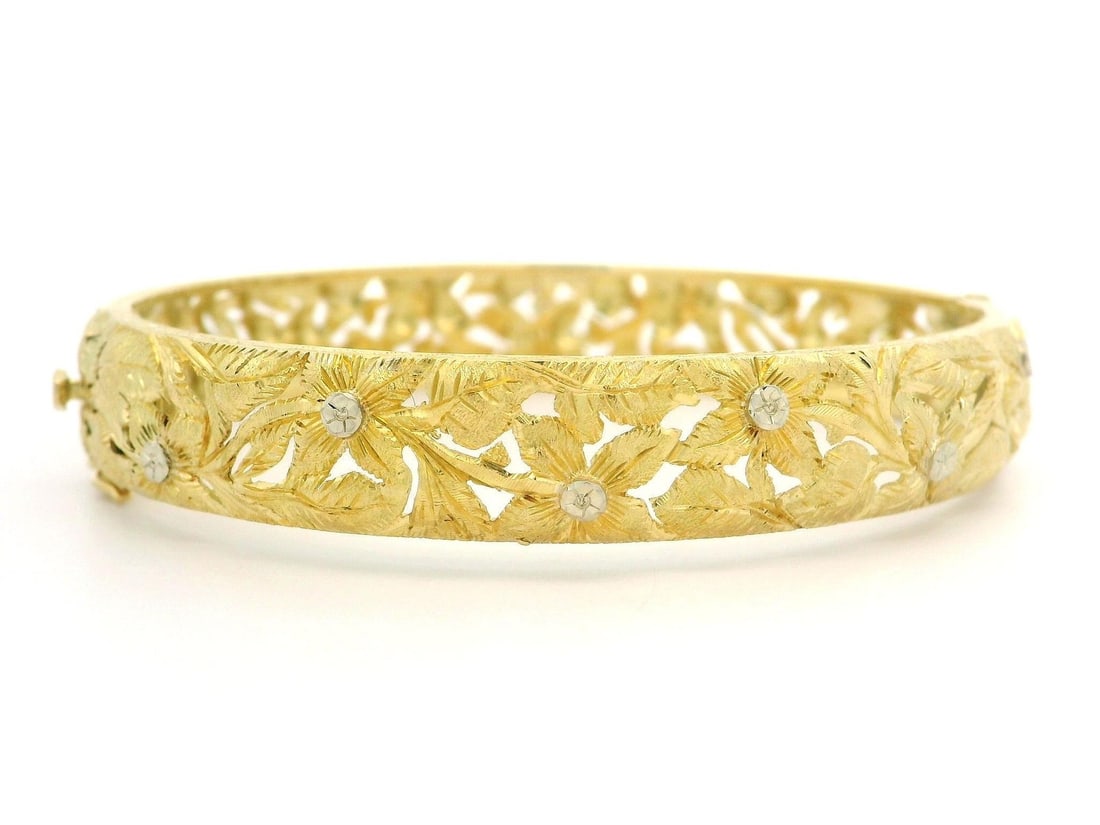 18k Yellow Gold Floral Engraved Hinged Bracelet Signed Meini: 18k Yellow Gold Floral Engraved Hinged Bracelet Signed Meini This vintage hinged bracelet is crafted from solid 18k yellow gold with white gold accents. It features intricate hand-engraved floral deta