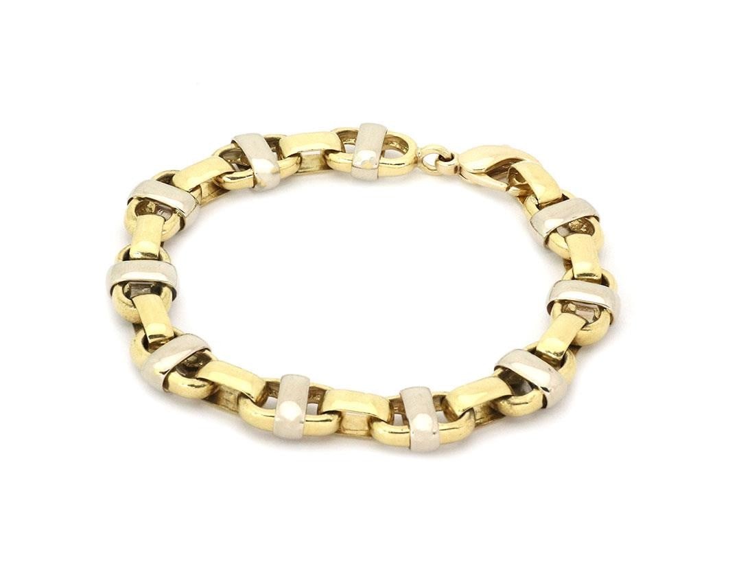 18k Yellow White Gold Mariner Link Mens Bracelet 66g 9in: 18k Yellow White Gold Mariner Link Mens Bracelet 66g 9in This striking men's bracelet is expertly crafted from 18k yellow and white gold, featuring substantial 12mm wide mariner links. The design incl