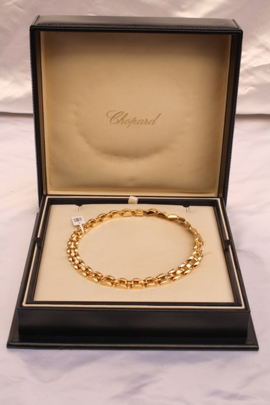Chopard 18K Gold Diamond Choker Necklace with Original Box: Chopard 18K Gold Diamond Choker Necklace with Original Box Discover the elegance of this Chopard Swiss-made necklace, crafted from luxurious 18K yellow gold and adorned with sparkling diamonds. This e