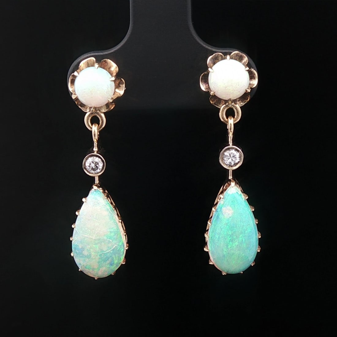 Vintage Victorian Revival Yellow Gold Opal Diamond Dangle Earrings: Vintage Victorian Revival Yellow Gold Opal Diamond Dangle Earrings These exquisite Vintage Victorian Revival Dangle Earrings feature a stunning design in solid yellow gold. Each earring is adorned wit
