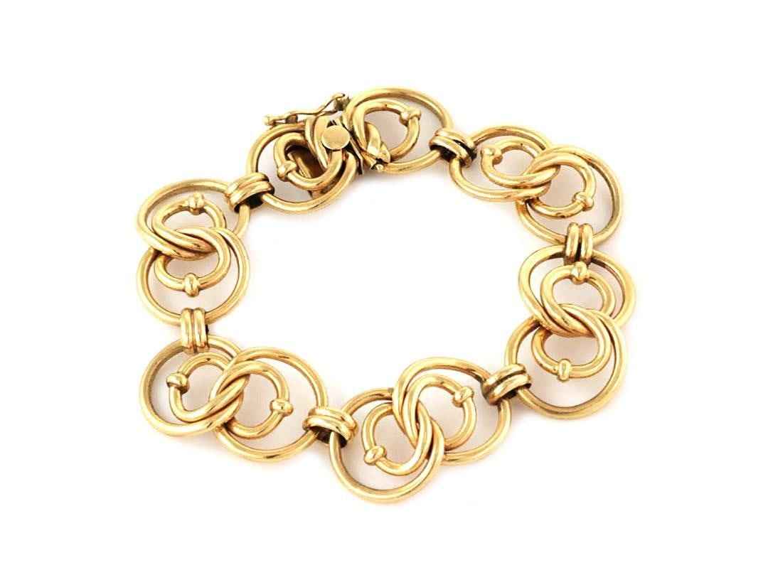 14k Yellow Gold Bracelet with Double Figure 8 and Oval Rib Links: 14k Yellow Gold Bracelet with Double Figure 8 and Oval Rib Links This exquisite bracelet is made from 14k yellow gold, showcasing a unique design with double figure 8 links. Between each pair of doubl