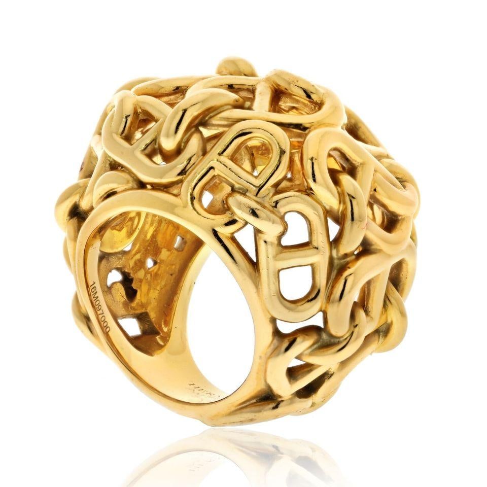 Hermes 18K Yellow Gold Cha?ne d'Ancre Dome Ring with Certificate: Hermes 18K Yellow Gold Cha?ne d'Ancre Dome Ring with Certificate This exquisite Hermes 18K Yellow Gold Cha?ne d'Ancre Dome Cocktail Ring is a stunning representation of the brand's artistry and dedica