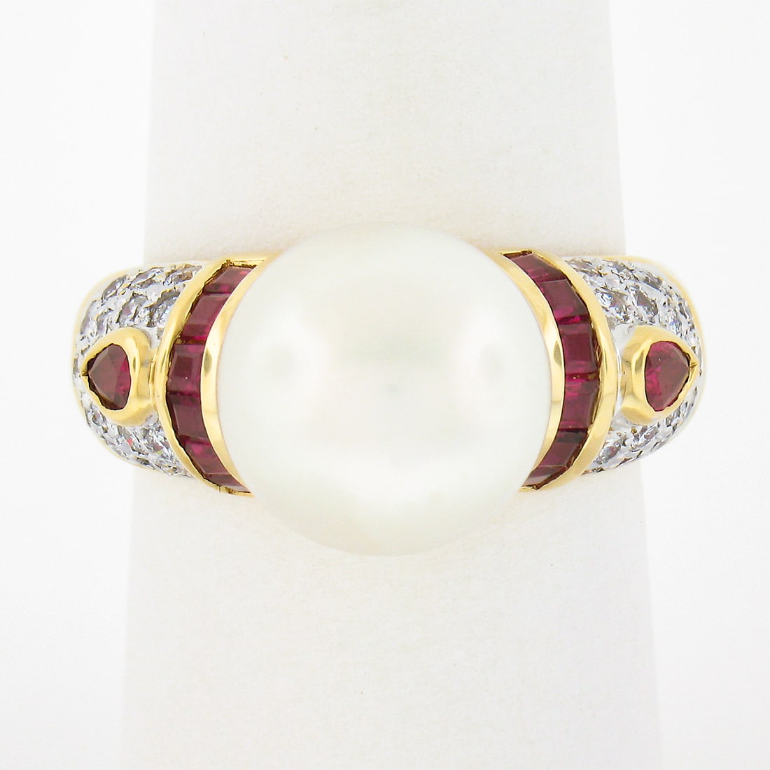 Elegant 18K Yellow Gold 11mm Pearl Ring with Ruby and Diamond Accents: Elegant 18K Yellow Gold 11mm Pearl Ring with Ruby and Diamond Accents This exquisite Fancy 18K Yellow Gold Ring showcases an 11mm round cultured white pearl at its center, radiating a beautiful luster