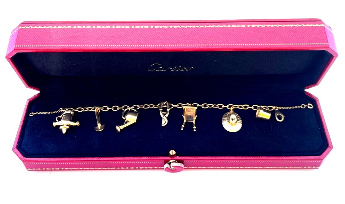 Cartier 18K Yellow Gold Charm Bracelet with 7 Garden Charms & Box: Cartier 18K Yellow Gold Charm Bracelet with 7 Garden Charms & Box This exquisite Cartier charm bracelet, crafted from 18K yellow gold, features a delightful assortment of 7 garden-themed charms. Origi