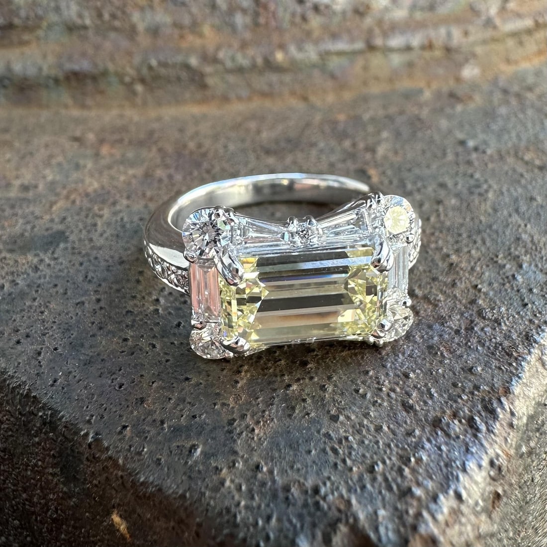 GIA Certified Platinum Band Ring With 3.87ctw Faint Yellow Emerald Diamond: GIA Certified Platinum Band Ring With 3.87ctw Faint Yellow Emerald Diamond This platinum bow band ring features a 3.00 carat GIA-certified natural emerald cut diamond set in an east-west orientation. 
