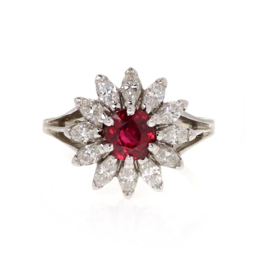 14k White Gold Floral Cocktail Ring with Ruby and Marquise Diamonds: 14k White Gold Floral Cocktail Ring with Ruby and Marquise Diamonds This exquisite cocktail ring is crafted from 14k white gold and features a stunning floral design. At its center, a round ruby gemst