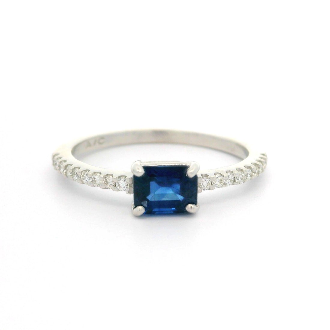 14k White Gold 0.99ct Sapphire Diamond Sideways Promise Ring: 14k White Gold 0.99ct Sapphire Diamond Sideways Promise Ring This elegant petite promise ring features a stunning 14k white gold band adorned with a royal blue natural sapphire and sparkling diamonds.