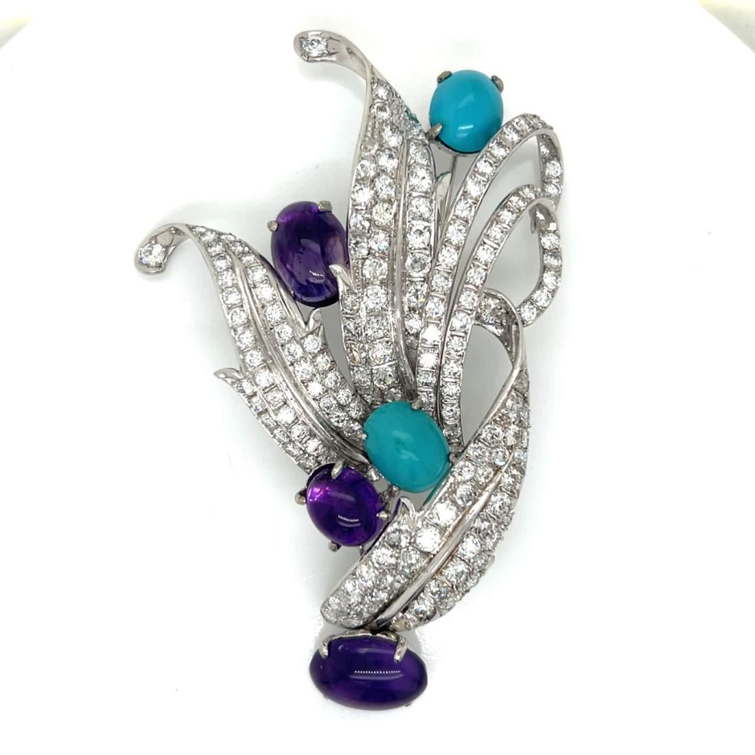 1960's Platinum Brooch with 159 Diamonds and Amethysts: 1960's Platinum Brooch with 159 Diamonds and Amethysts This exquisite 1960's brooch features a striking combination of platinum, diamonds, amethysts, and turquoise. It weighs 40.4 grams and is adorned