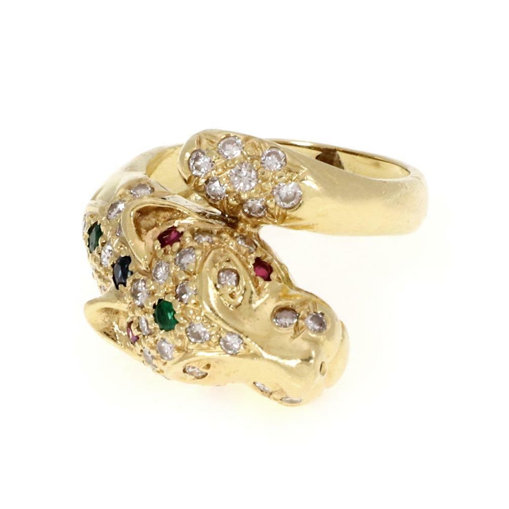 18k Yellow Gold Panther Head Bypass Ring with Diamonds and Gems: 18k Yellow Gold Panther Head Bypass Ring with Diamonds and Gems This exquisite bypass ring is crafted from 18k yellow gold, showcasing a stunning panther's head and tail adorned with approximately 40 
