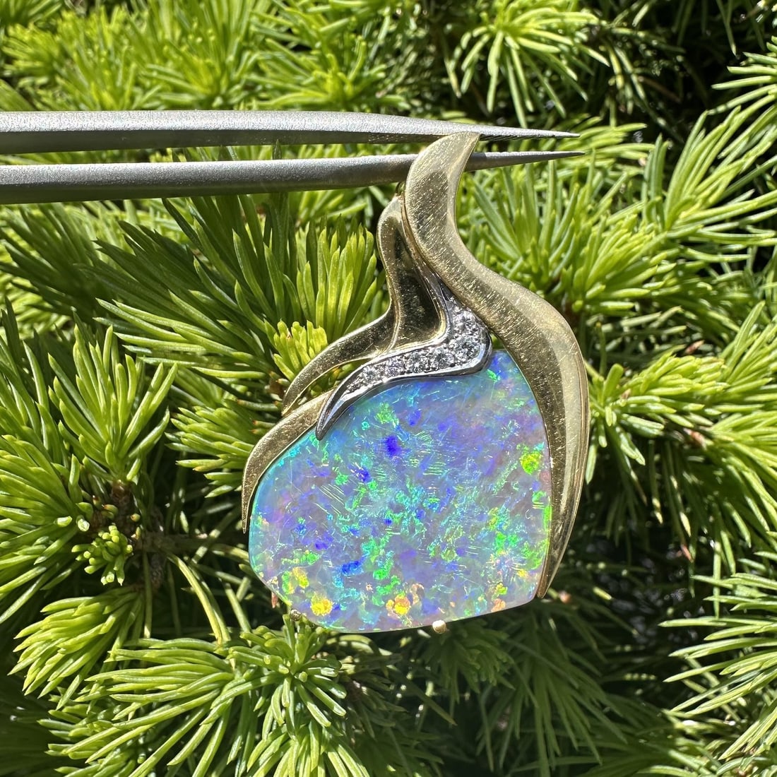 18k Yellow Gold Opal Slide Pendant with Diamond Accents: 18k Yellow Gold Opal Slide Pendant with Diamond Accents This pendant features a freeform natural boulder opal displaying a fiery play of colors, prong set in solid 18k yellow gold with white gold acce