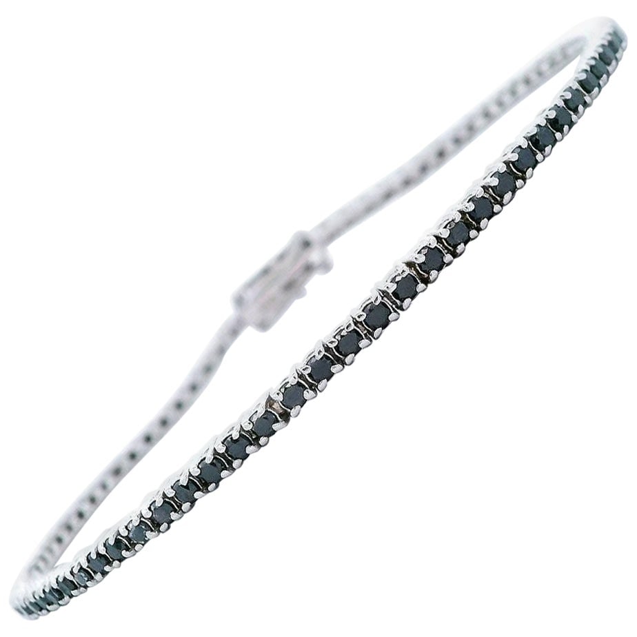 1.77ct Black Diamond Tennis Bracelet in 14k White Gold: 1.77ct Black Diamond Tennis Bracelet in 14k White Gold This exquisite tennis bracelet features 81 round-cut natural black diamonds totaling 1.77 carats, elegantly set in luxurious 14k white gold. The 