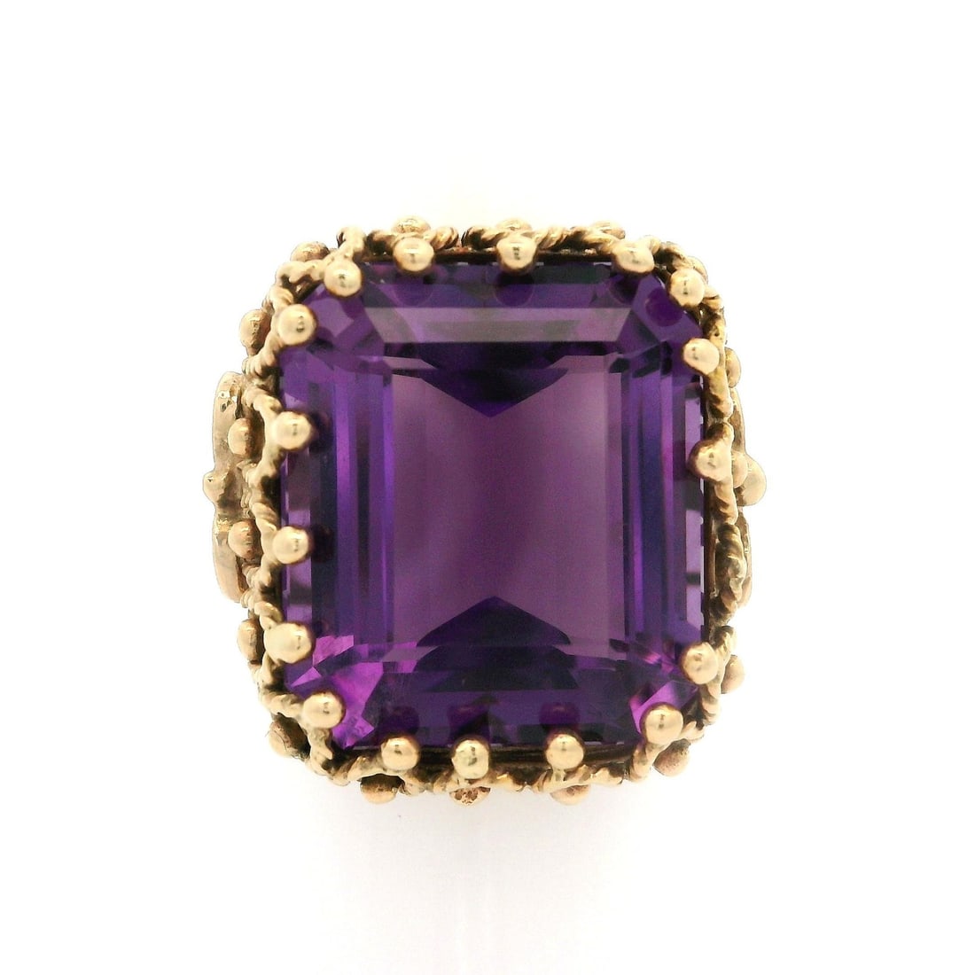 Vintage Handmade 14k Yellow Gold Amethyst Cocktail Ring 12ct: Vintage Handmade 14k Yellow Gold Amethyst Cocktail Ring 12ct This exquisite vintage cocktail ring showcases a stunning natural genuine amethyst, characterized by a deep purple hue and a rectangular st