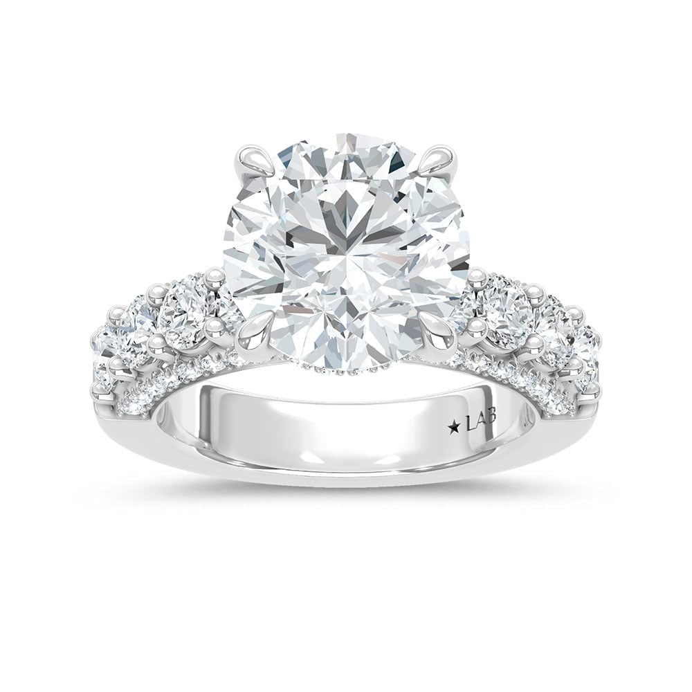 14K White Gold Lab Grown Diamond 6 7/8 Ct.Tw. Engagement Ring (Center 5ct): 14K White Gold Lab Grown Diamond 6 7/8 Ct.Tw. Engagement Ring (Center 5ct) Discover subtle brilliance and modern elegance with our Hidden Halo Diamond Engagement Ring. This elegant engagement ring fea