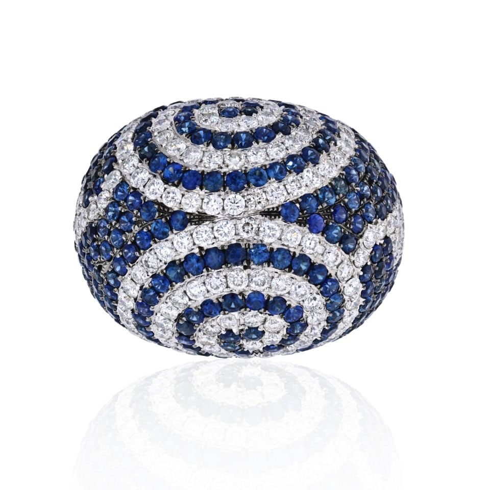 Large Dome Ring 18K White Gold with 140 Diamonds 240 Sapphires: Large Dome Ring 18K White Gold with 140 Diamonds 240 Sapphires This stunning large dome ring is crafted from 18K white gold and features a dazzling arrangement of round cut diamonds and sapphires. Wit