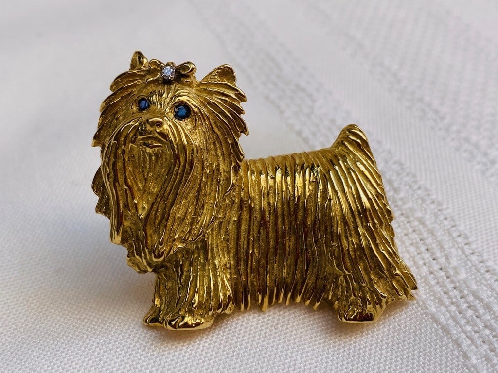 18K Yellow Gold Diamond Sapphire Dog Brooch Signed BHO: 18K Yellow Gold Diamond Sapphire Dog Brooch Signed BHO This exquisite brooch showcases a charming dog design crafted from 18K yellow gold, adorned with sparkling diamond and sapphire accents. The piec
