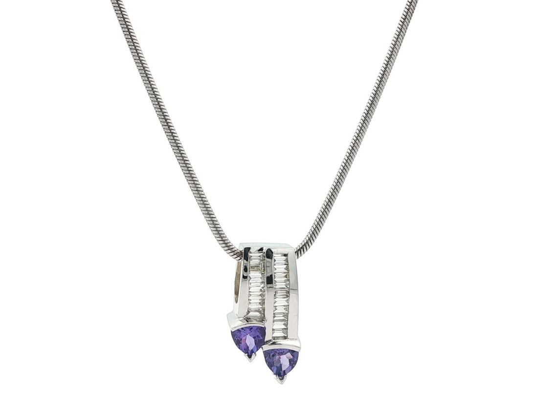 14k White Gold Tanzanite Diamond Dual Drop Pendant with 18 Inch Chain: 14k White Gold Tanzanite Diamond Dual Drop Pendant with 18 Inch Chain Elevate your jewelry collection with this stunning 14k White Gold Tanzanite and Diamond Slide Dual Drop Pendant. Featuring two nat