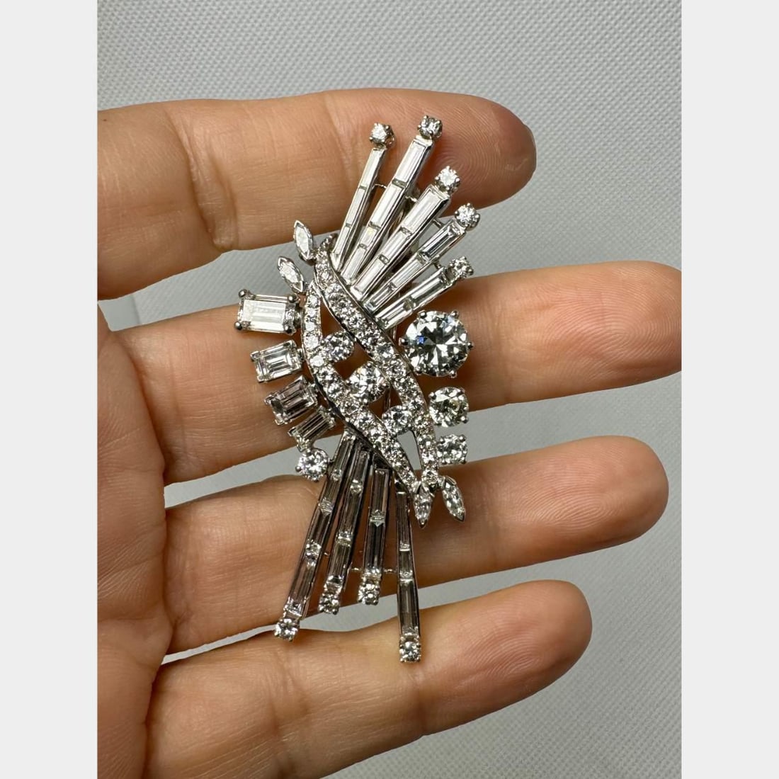 1950's Platinum Diamond Brooch GIA Certified 1.55 Ct Vintage Elegance: 1950's Platinum Diamond Brooch GIA Certified 1.55 Ct Vintage Elegance This stunning 1950's Platinum brooch is a true statement piece, featuring a GIA Certified 1.55 Ct. diamond with H color and VS2 cl