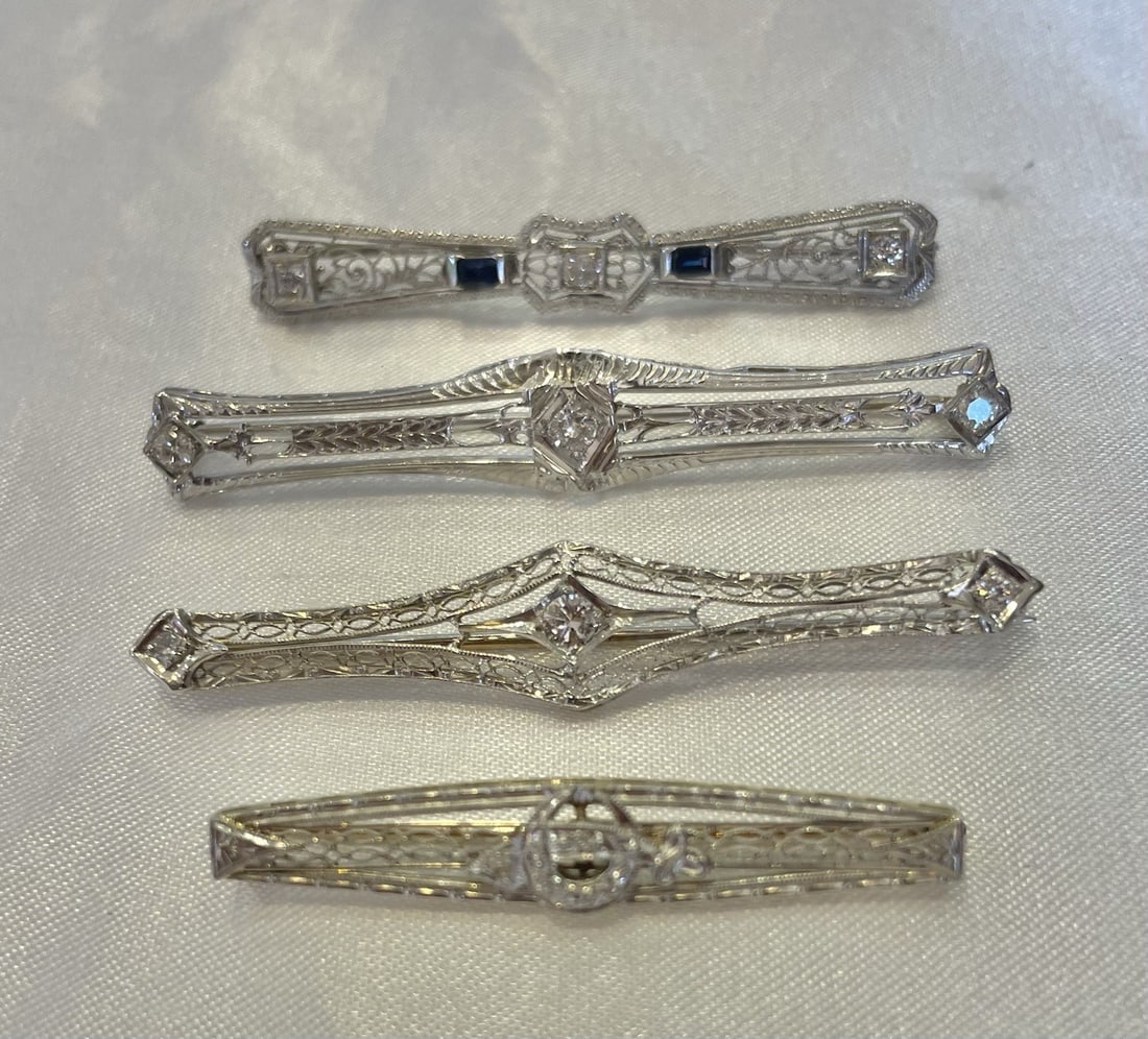 Art Deco platinum sapphire diamond bar brooch set of 4: Art Deco platinum sapphire diamond bar brooch set of 4 This is a remarkable collection of four Art Deco bar brooches from the 1930s, crafted in platinum and accented with diamonds and sapphires. The s