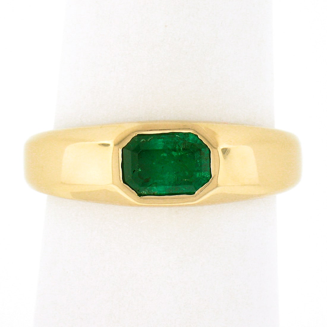 14K Yellow Gold 0.66ct Green Emerald Sideways Bezel Solitaire Ring: 14K Yellow Gold 0.66ct Green Emerald Sideways Bezel Solitaire Ring This exquisite unisex ring features a stunning natural green emerald, beautifully set in a sideways bezel within a solid 14K yellow g