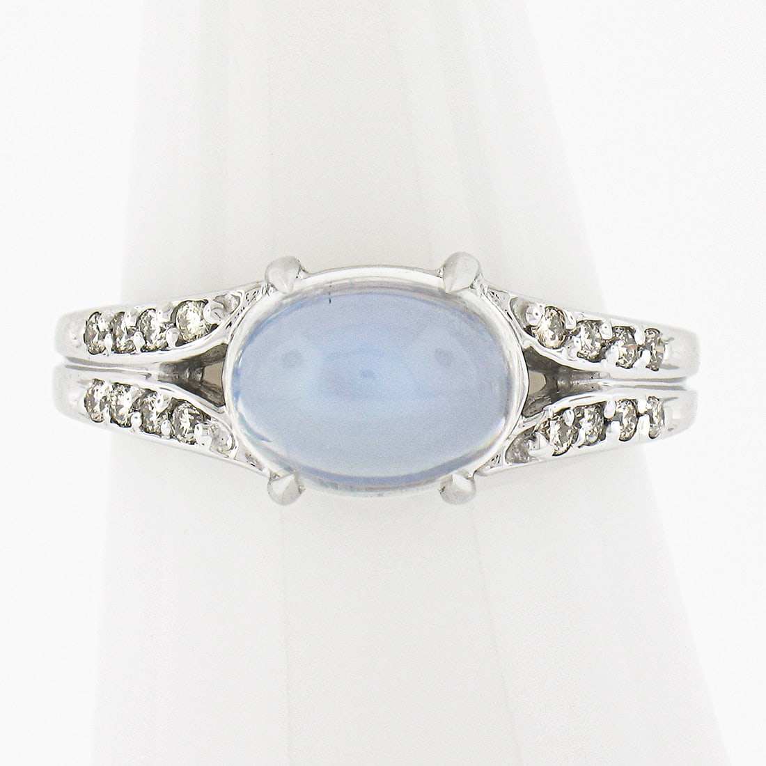 14k White Gold 3.54ct Oval Blue Moonstone Diamond Ring: 14k White Gold 3.54ct Oval Blue Moonstone Diamond Ring This stunning ring features a natural genuine blue moonstone, expertly crafted in a gorgeous oval cabochon cut. The moonstone, measuring 9.7x7.5m