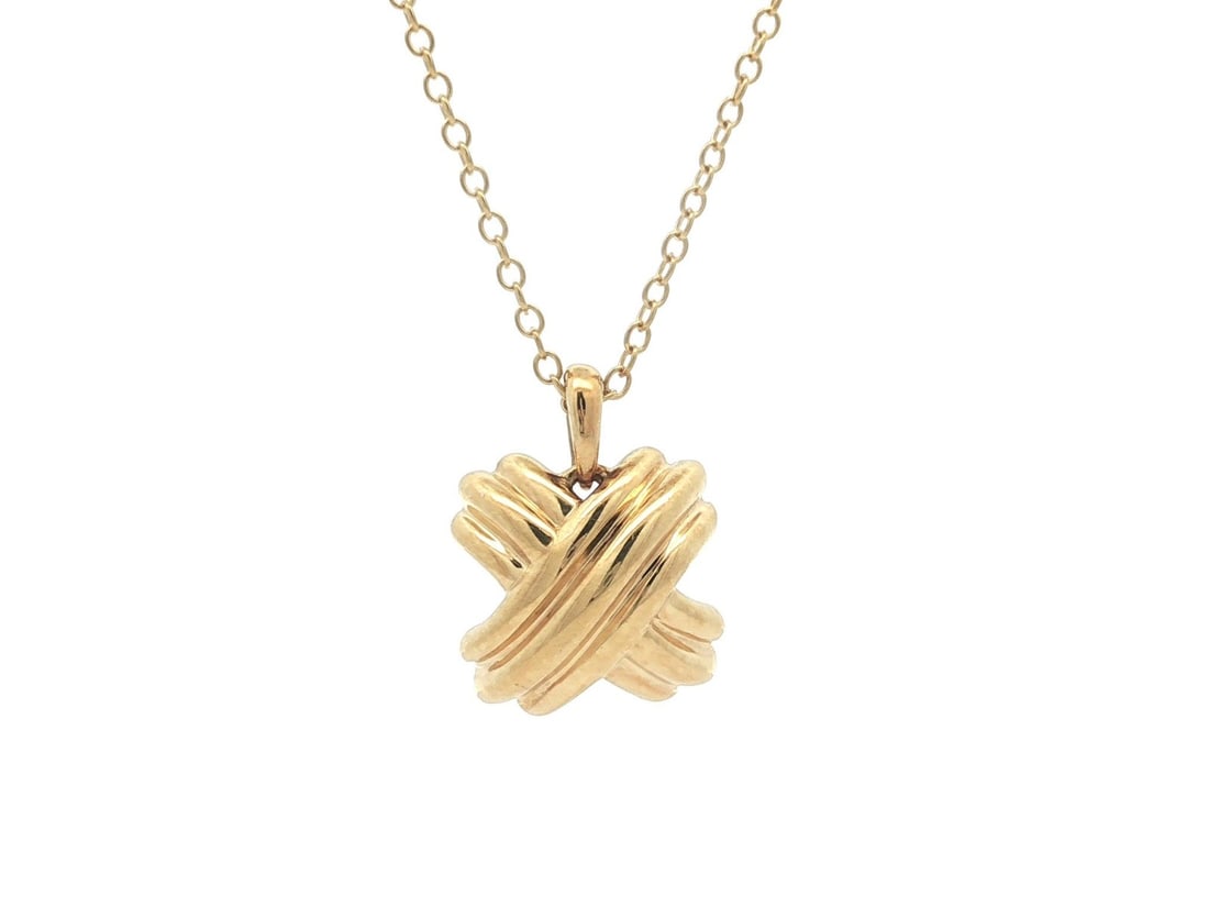 Tiffany Signature X Pendant Necklace in 18k Yellow Gold 16 Inch Vintage: Tiffany Signature X Pendant Necklace in 18k Yellow Gold 16 Inch Vintage This vintage Tiffany & Co. necklace features a solid 18k yellow gold "X" signature pendant on a 16-inch cable link chain. The pi