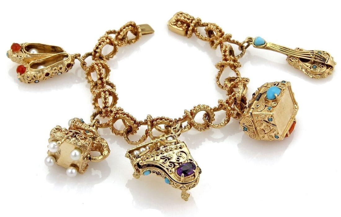 14k Yellow Gold Charm Bracelet with 5 Gemstone Pearl Charms: 14k Yellow Gold Charm Bracelet with 5 Gemstone Pearl Charms A vintage estate charm bracelet crafted in solid 14k yellow gold, featuring a fancy floral link chain and five large articulated charms. The