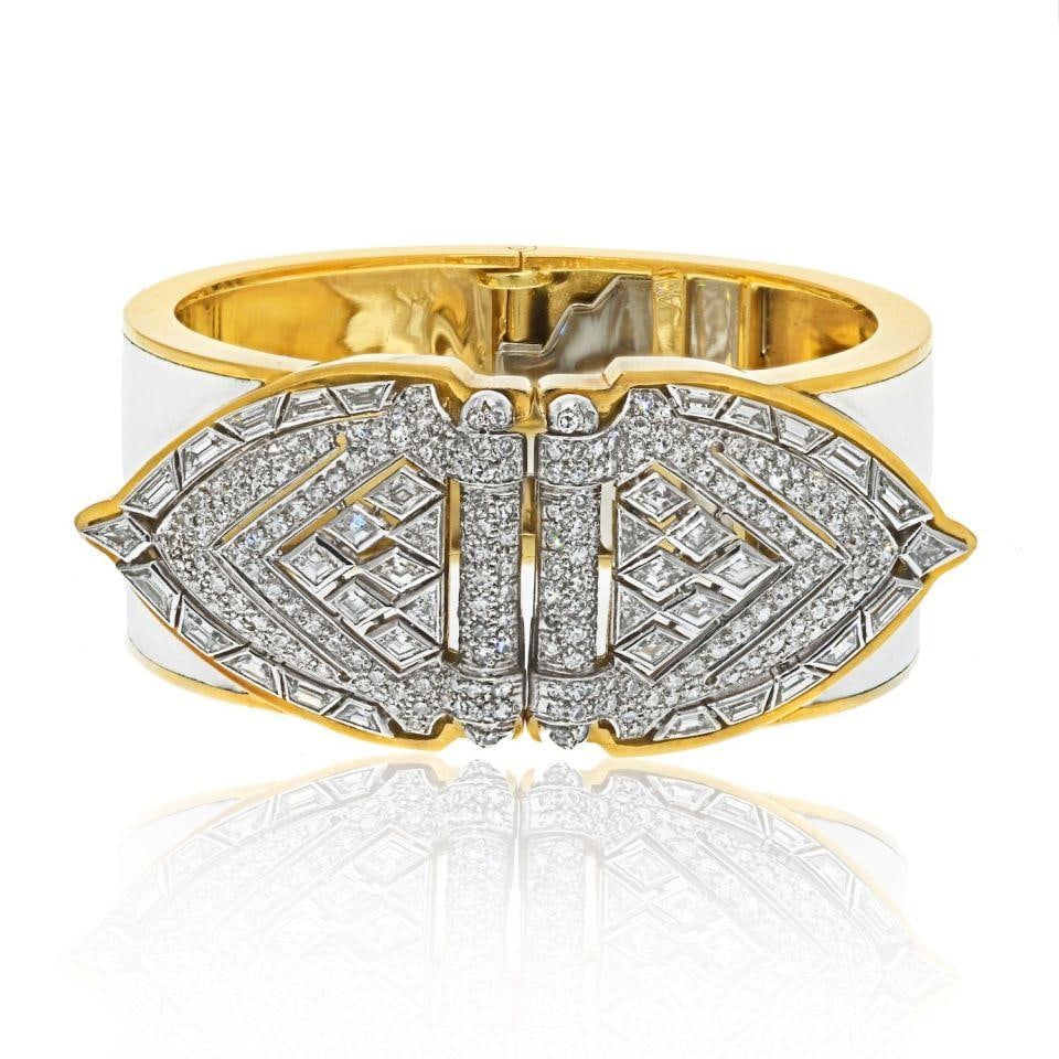 White Enamel Cuff Bracelet With Platinum Diamond Shield Clips by David Webb: White Enamel Cuff Bracelet With Platinum Diamond Shield Clips by David Webb This David Webb cuff bracelet features a striking design crafted from platinum and 18K yellow gold with white enamel accents