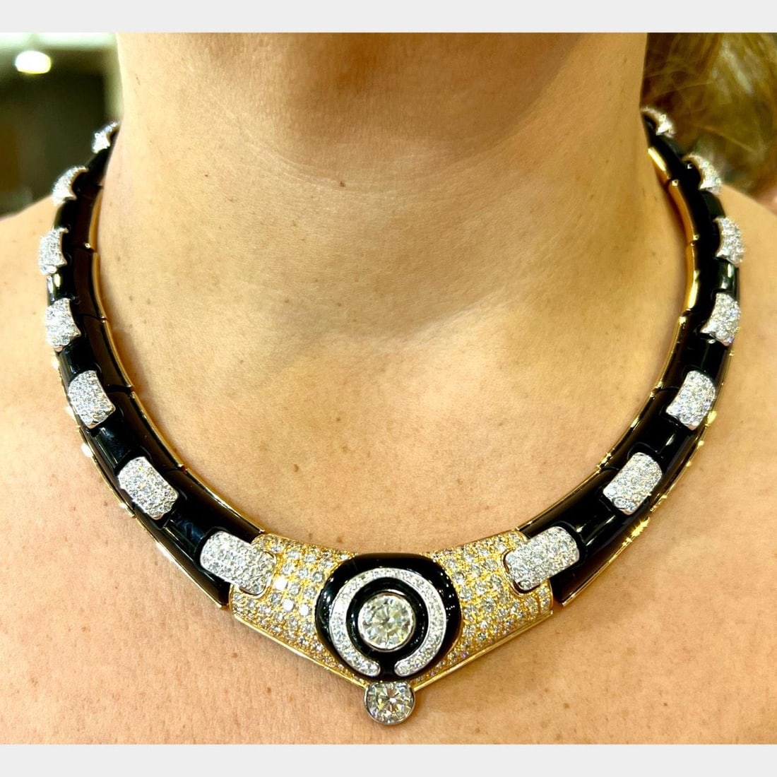 Diamond and Onyx Statement Necklace in 18K Yellow Gold: Diamond and Onyx Statement Necklace in 18K Yellow Gold This pre-owned necklace is crafted from 18K yellow gold and features onyx accents. It is set with 2 diamonds totaling approximately 4.00 carats, 