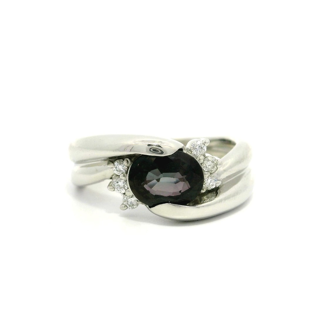 GIA Certified 1.19ctw Oval Purple Sapphire Diamond Platinum Ring: GIA Certified 1.19ctw Oval Purple Sapphire Diamond Platinum Ring This exquisite bypass style ring features a stunning natural oval purple sapphire, channel set and weighing 1.11 carats, accompanied by