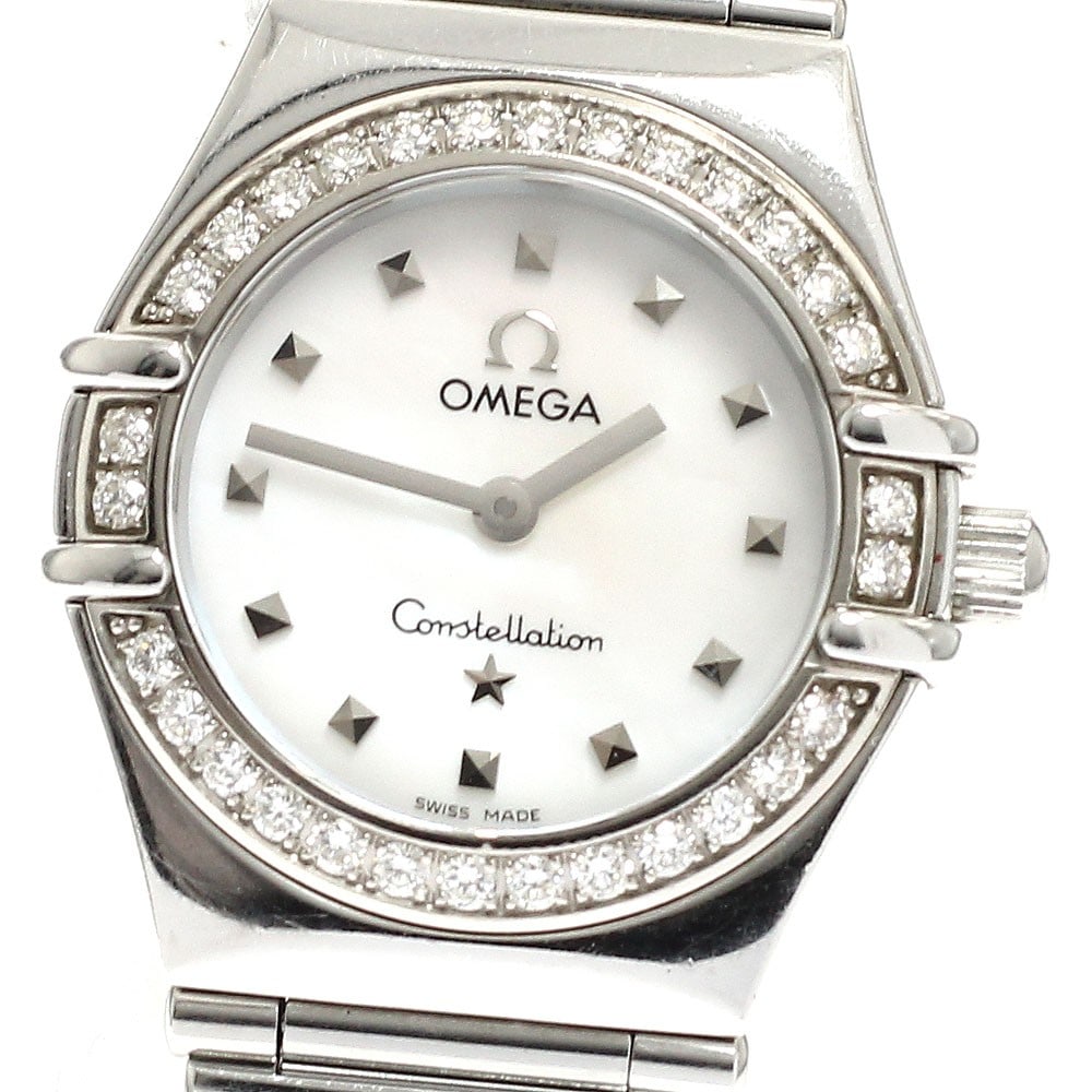 Omega Constellation ladies quartz watch diamond bezel 1465.71: Omega Constellation ladies quartz watch diamond bezel 1465.71 This OMEGA Constellation ladies wristwatch features a stainless steel case and bracelet, accented by a diamond bezel. The white mother-of-