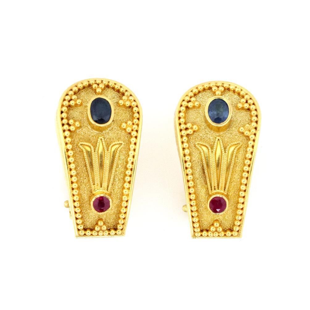 18k Yellow Gold Floral Earrings with Sapphire and Ruby Gemstones: 18k Yellow Gold Floral Earrings with Sapphire and Ruby Gemstones Elevate your jewelry collection with these exquisite 18k Yellow Gold Sapphire & Ruby Greek Style Floral Post Clip Earrings. Crafted fro