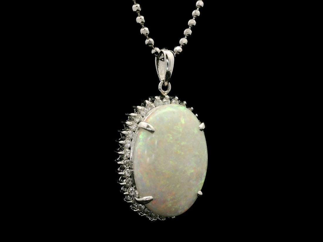 Platinum Pendant with Large Blue Opal and Diamond Halo on 18 Inch Chain: Platinum Pendant with Large Blue Opal and Diamond Halo on 18 Inch Chain This stunning pendant features a large, natural blue opal in an oval cabochon shape, displaying a captivating play of colors inc
