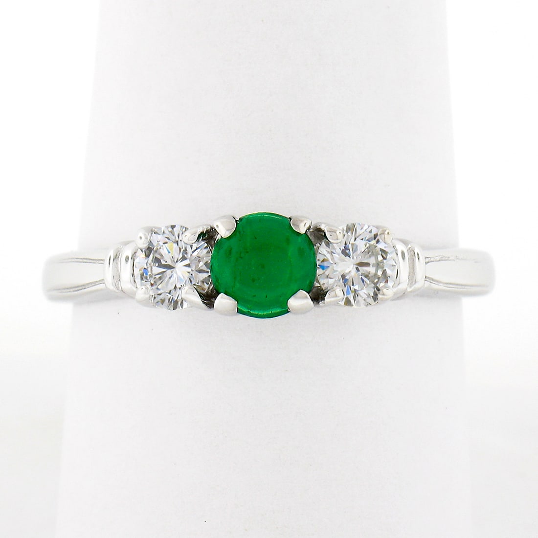 Vintage 14k White Gold Emerald Diamond Three-Stone Ring: Vintage 14k White Gold Emerald Diamond Three-Stone Ring This stunning vintage ring is crafted from solid 14k white gold, featuring a captivating three-stone design. At its center lies a natural round 