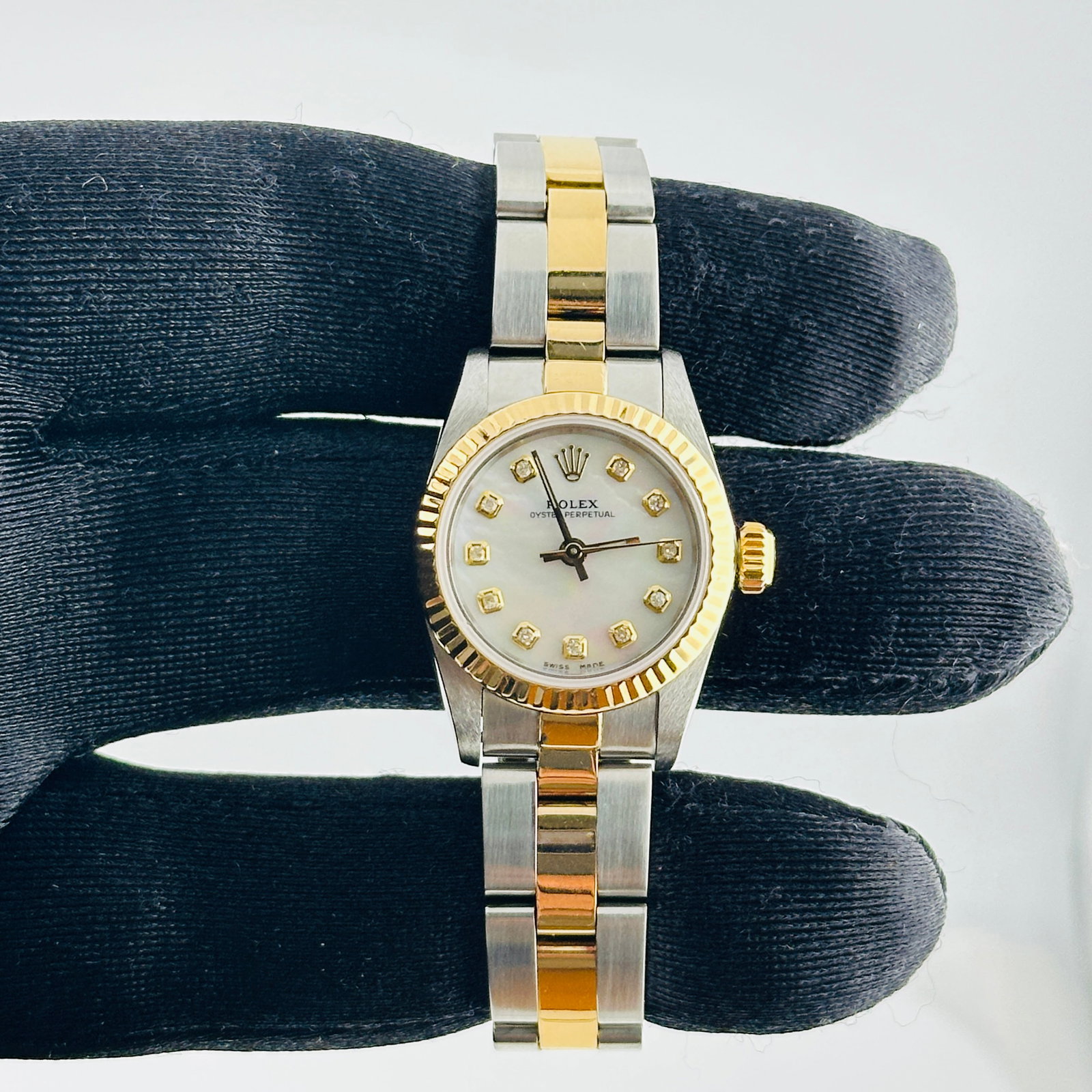 Ladies Rolex Oyster Perpetual 67193 Pink Yellow Diamond Dial Oyster Bracelet: Ladies Rolex Oyster Perpetual 67193 Pink Yellow Diamond Dial Oyster Bracelet This ladies' Rolex Oyster Perpetual features a distinctive Aftermarket pink dial with yellow diamond markers. The watch is 