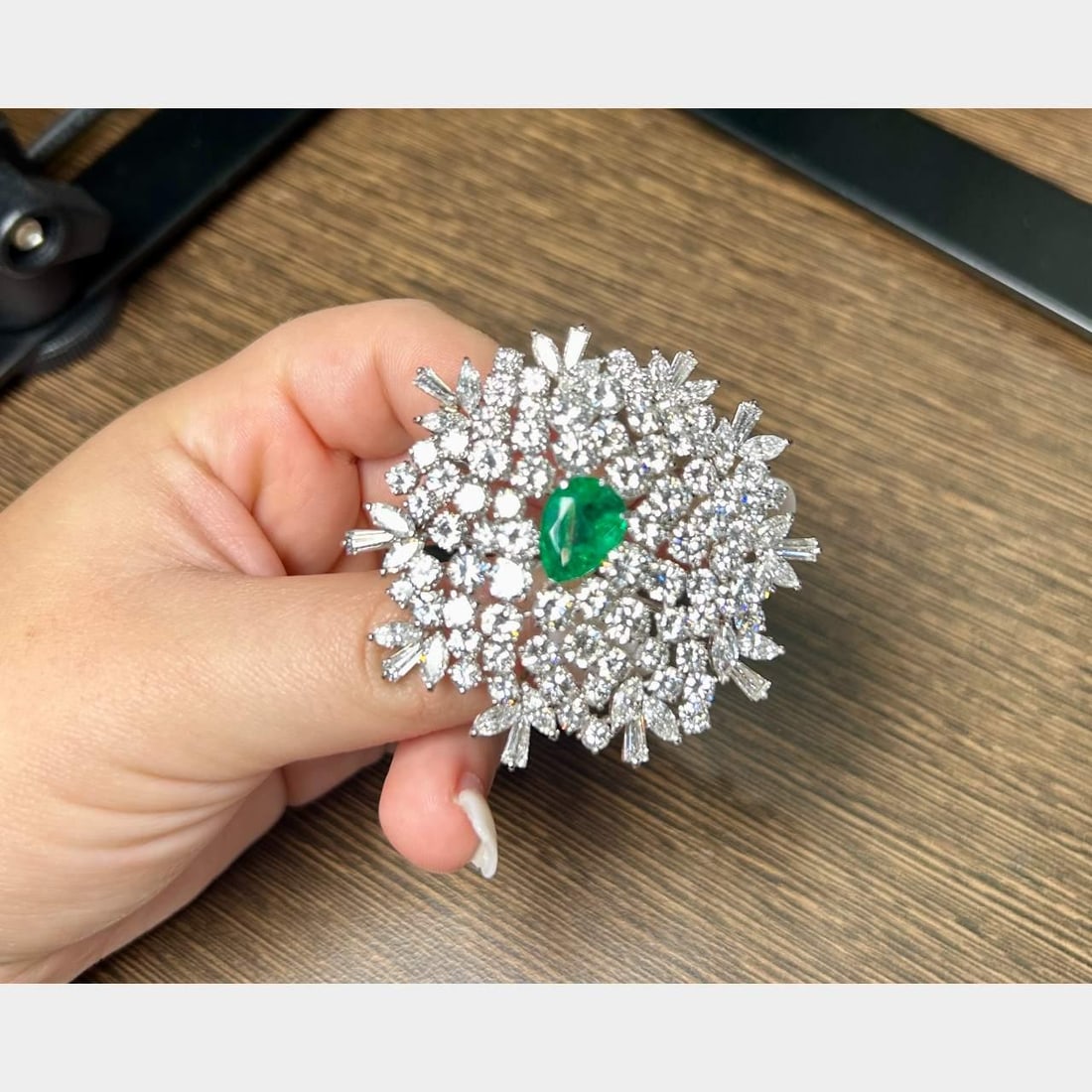 Platinum Brooch with 23.00 Ct Diamonds and 3.75 Ct Colombian Emerald: Platinum Brooch with 23.00 Ct Diamonds and 3.75 Ct Colombian Emerald This exquisite brooch features a stunning combination of a 3.75 Ct. Colombian emerald and approximately 23.00 Ct. of sparkling diam