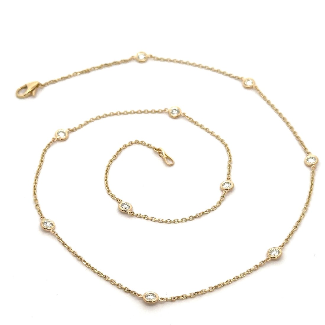 14k Yellow Gold 1ctw Diamond By The Yard 18" Necklace: 14k Yellow Gold 1ctw Diamond By The Yard 18" Necklace This exquisite 14k yellow gold necklace features a stunning arrangement of 10 natural round brilliant cut diamonds, totaling 1.0 carat weight. Des