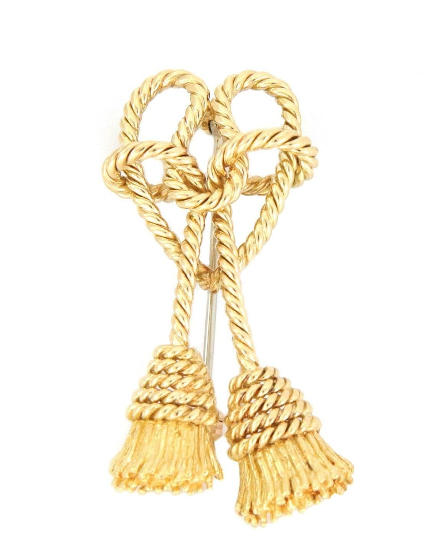 Tiffany & Co. 18k Yellow Gold Heart Bow Tassel Pin: Tiffany & Co. 18k Yellow Gold Heart Bow Tassel Pin This elegant vintage brooch from Tiffany & Co. is crafted from 18k yellow gold with a polished finish. It features a twisted rope-style ribbon formin